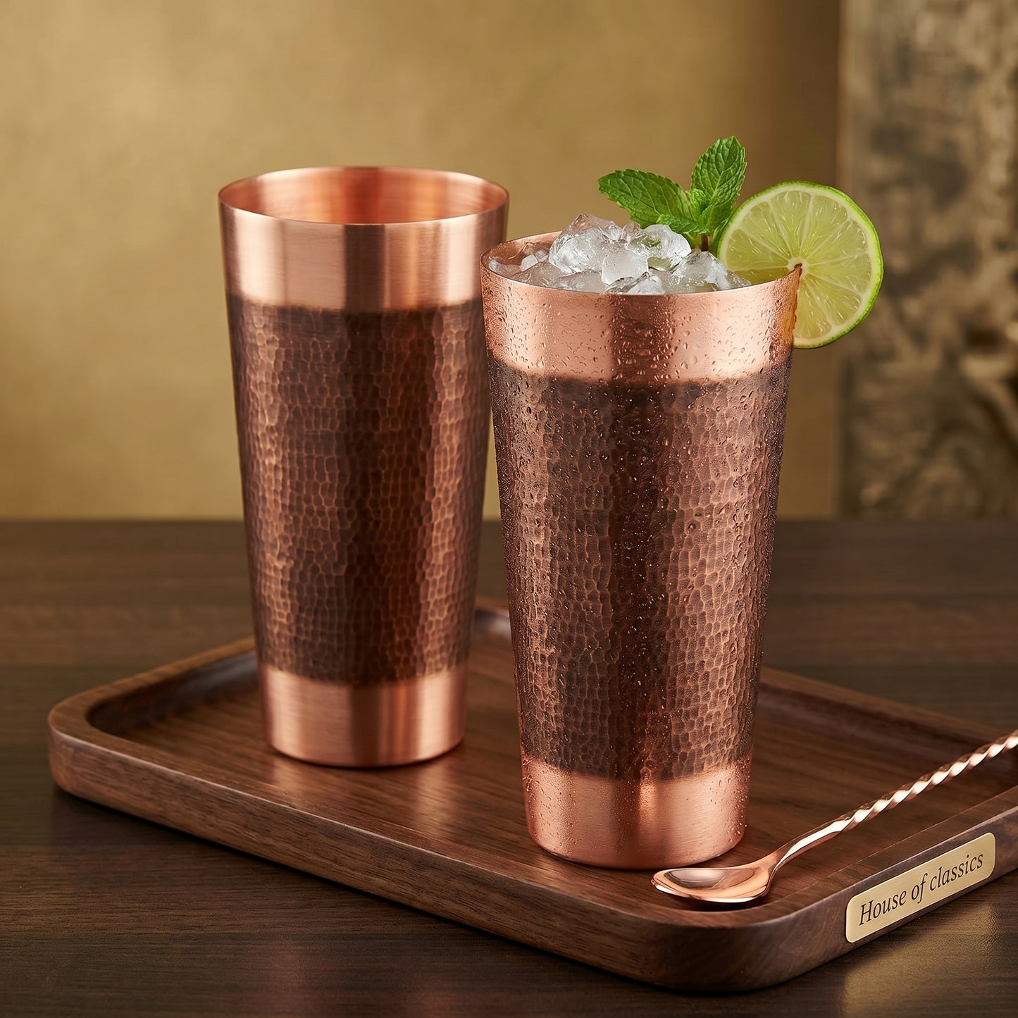 Two copper tumblers with a drink on a wooden tray