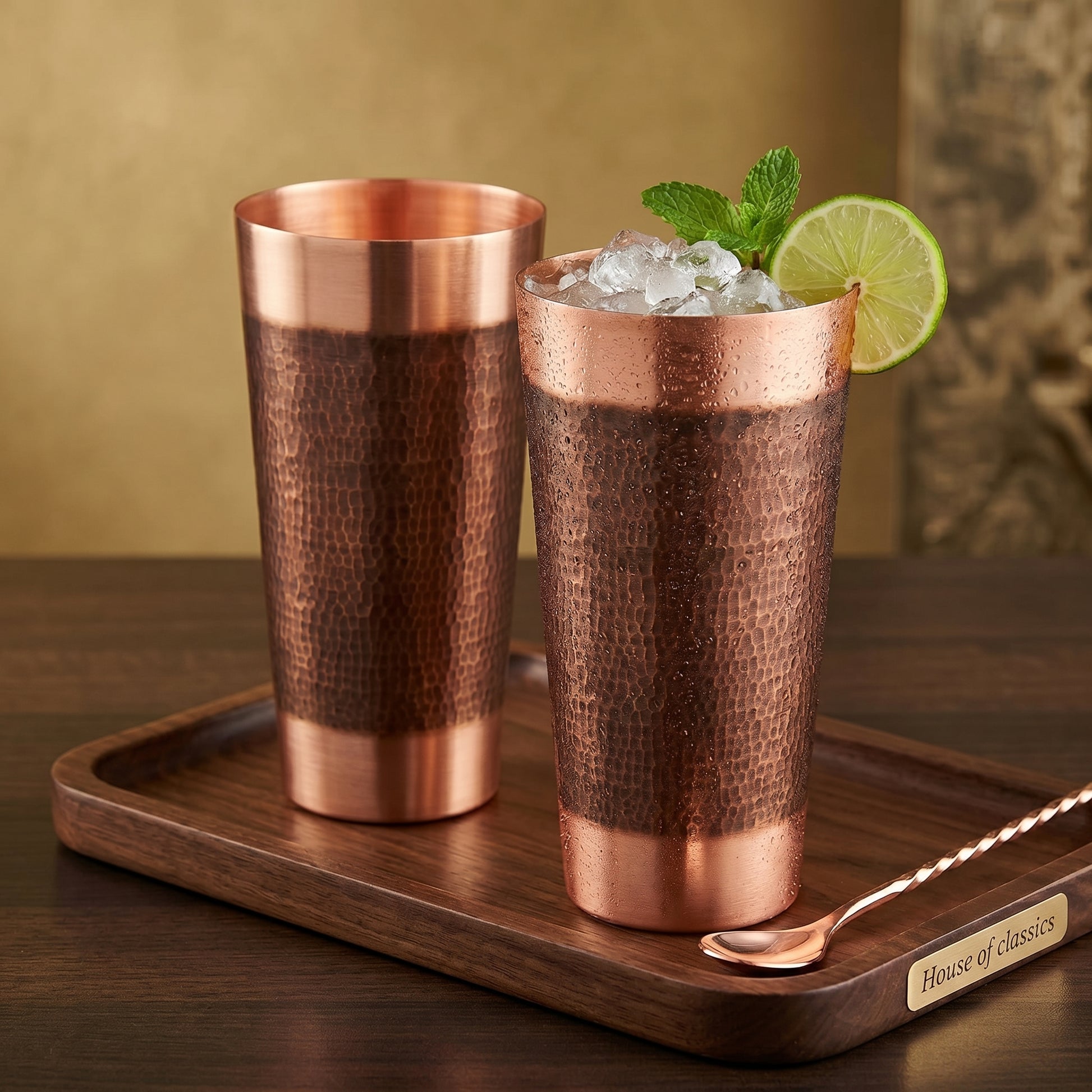Two copper tumblers with a drink on a wooden tray